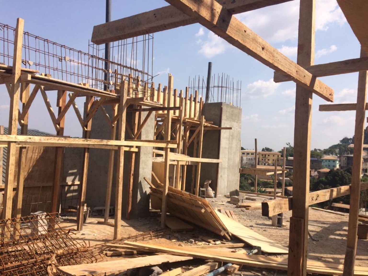 Upper-level construction at Golf Residences showing timber formwork, reinforcement, and the emerging vertical façade elements.